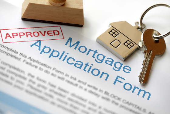 Mortgage application form with an Approved stamp confirming 100% mortgage available